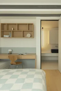 A modern bathroom with wooden walls and a checkered bedspread.