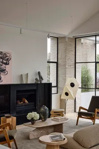 A modern living room featuring a mix of marble and concrete materials with minimalist furniture and a fireplace.