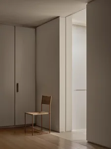 A minimalist bedroom featuring wood elements.