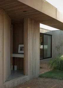 A wooden doorway leading into a designed architectural space.