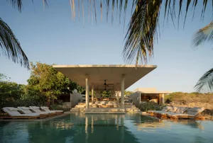 A contemporary patio with concrete and wooden elements in a minimalist design.