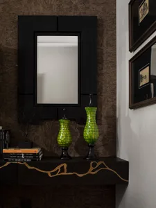 A modern console table with black and gold decorative elements