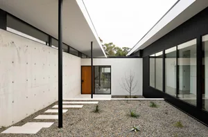 A modern house with a concrete roof and walls, featuring a minimalist design.