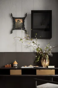 A modern desk space featuring a combination of materials including leather, wood, and metal.