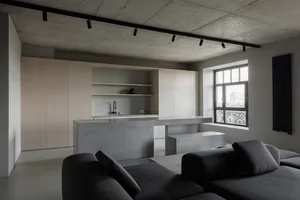 Modern kitchen featuring concrete countertops and cabinets, minimalist design.