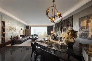 Modern living and dining room featuring marble finishes and glass elements