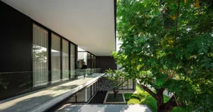 Modern residential interior design featuring glass elements and open-concept layout.