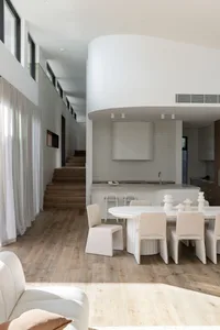現代簡約室內，木質地板、混凝土牆面與布料沙發家具。