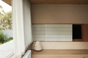 Modern minimalist residential interior with wooden flooring and natural light.