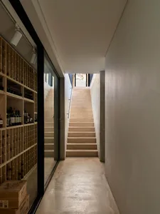 Modern interior space featuring concrete stairs and a library.