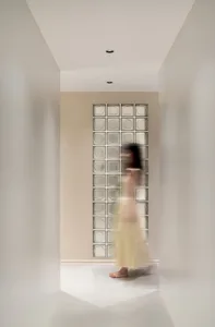 A minimalist interior with glass blocks in a light-colored corridor