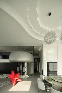 Modern living room with minimalist design and concrete flooring.