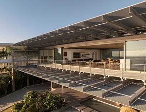 Modern residential exterior featuring metal, glass, and wooden elements