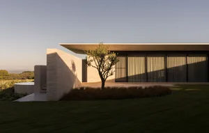 Modern residential house with brick and large glass windows.