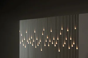 Modern interior wall featuring vertical metal strips with embedded lights.