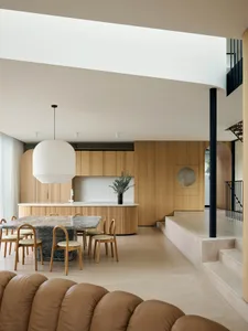 Modern interior design featuring a kitchen dining space with wood materials.