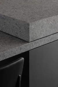 Close-up of a modern kitchen featuring a sleek granite countertop.