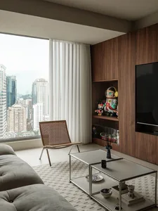 Modern living room with city view featuring wood and metal elements.