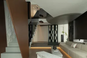 Modern living room with a stylish staircase intersection featuring a mix of materials.