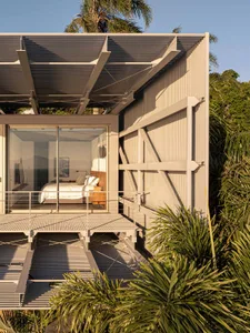 Modern residential home featuring metal and glass materials with a minimalist design.