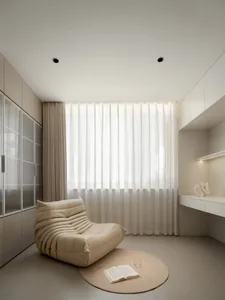 A serene bedroom with a beige armchair, an open book, and a glass of water on a round rug.