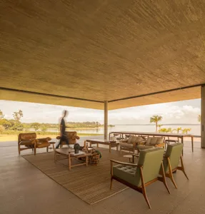 Modern living room featuring concrete, canvas, and wood furniture.