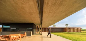 A modernist residential kitchen with a concrete ceiling and floor.
