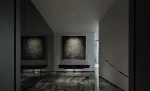 Interior design of a modern minimalist lobby featuring concrete finishes and space.