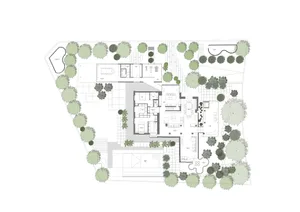 Detailed architectural plan of a residential house showing the layout on the ground floor with various rooms and outdoor spac