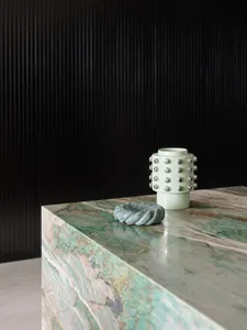 A modern-style, marble accessory with ceramic accents on a polished marble surface.