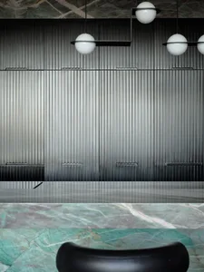 A modern minimalist interior with metallic panels and marble surfaces.