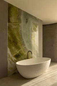 Modern bathroom interior featuring a freestanding bathtub with a polished marble backdrop.