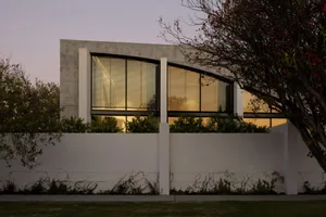 A modern residential building made of concrete with a unique sculptural design.