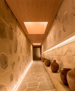 A modern corridor with a stone floor and concrete walls.