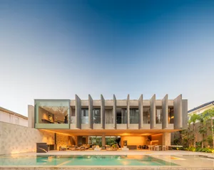 A modern residential building with concrete and glass features.
