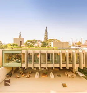 Modern residential building with a rooftop garden featuring concrete, glass, and roofgrass.