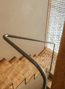 Modern staircase with wooden steps and metal railing