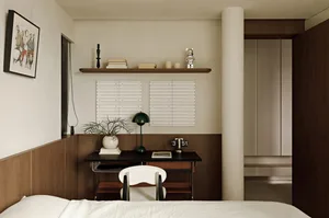 A minimalist bedroom featuring a white bed, wooden desk, and white chair.