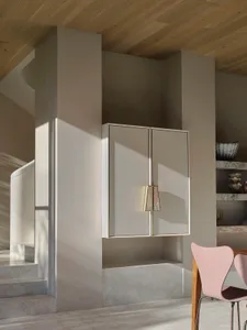 A modern interior design featuring clean lines and white cabinets.