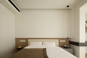 A minimalist bedroom with a bed, nightstands, and a hanging light fixture.