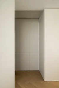 Modern, minimalist closet with white and light grey latex panels, showcasing sleek and functional design.