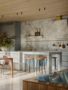 Modern kitchen with marble countertops and stools