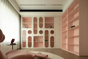 A minimalist living room featuring pink and white cabinets and shelves.
