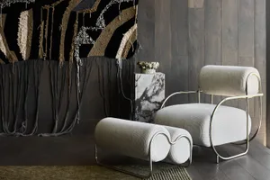 Modern living room with a white upholstered armchair and a metallic frame.