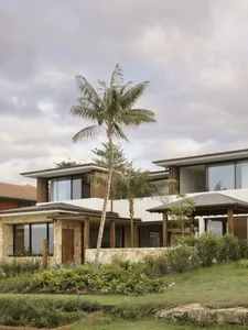A modern, residential building with a concrete facade and glass windows.