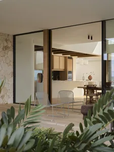 Modern residential living space featuring wooden furniture and stone elements.