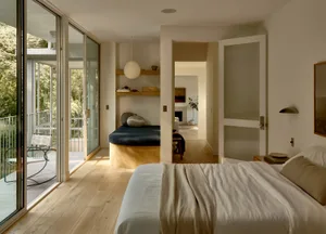 A serene minimalist bedroom with neutral tones and natural light.