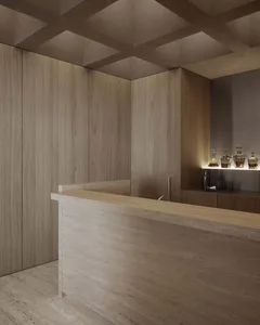 A minimalist hotel bar with wooden accents and a sleek, modern design.