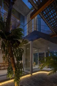 A minimalist residential interior featuring modern, concrete and glass materials.