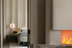 A minimalist bedroom with a concrete fireplace and white decor.